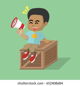 african boy sitting on crate