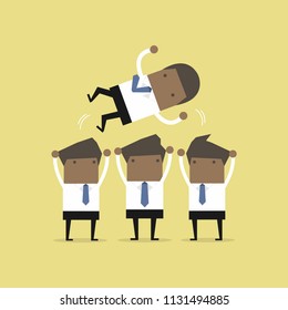 African businessman being throwing up by his teamwork.