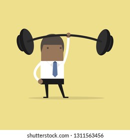 African businessman holding a heavy barbell with one hand.