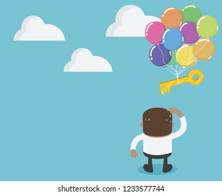 African businessman looking at a key that is drifting up from the sky. .It's like a success that fades away.