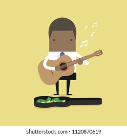 African businessman playing guitar for money.