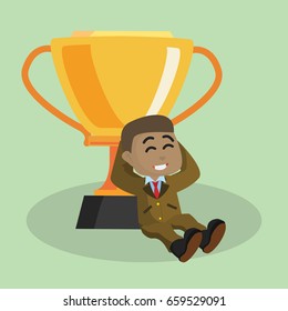 african businessman relaxing with trophy