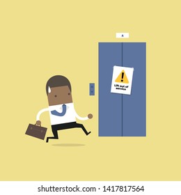 African businessman are running to the elevator. But the elevator is out of service.