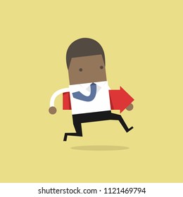 African businessman running and holding red arrow.