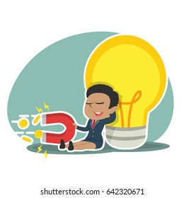 african businesswoman relaxing beside big bulb and pulling coin by magnet