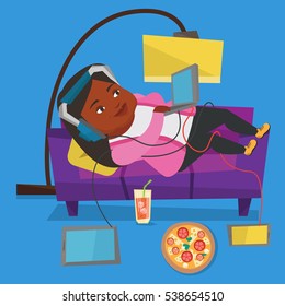 An african fat woman relaxing on a sofa with many gadgets. Woman lying on a sofa surrounded by gadgets and fast food. Plump woman using gadgets at home. Vector flat design illustration. Square layout.