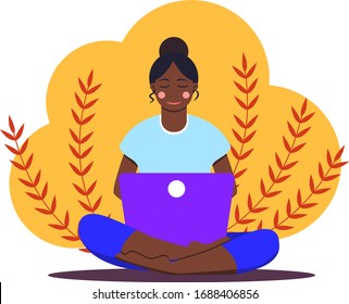 African girl sitting with laptop in lotus position. Young woman working on the notebook, studying, browsing internet, chatting, blogging. Online education or freelance. Stay home. Social distancing