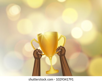 African male hand hold trophy cup with bokeh background