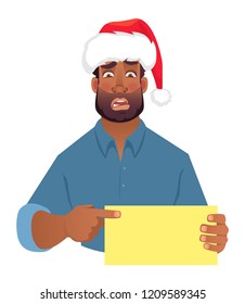 African man in christmas hat holding blank card. African american man pointing finger at card. Vector illustration