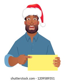 African man in christmas hat holding blank card. African american man pointing finger at card. Vector illustration