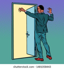 african man opens the door, greeting. Pop art retro vector illustration drawing