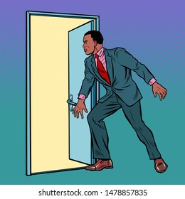 African man opens the door. Pop art retro vector illustration drawing