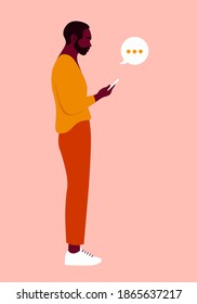 An African man is standing in profile and holding a smartphone. Figure of person in a full-length. Vector flat Illustration