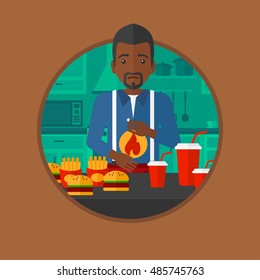 An african man suffering from heartburn. Man standing in the kitchen in front of table with junk food and suffering from heartburn. Vector flat design illustration in the circle isolated on background