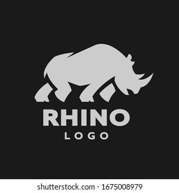 Afrikanische Rhinosilhouette. Logo, Symbol auf dunklem Hintergrund.