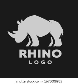 African rhino silhouette. Logo, symbol on a dark background.