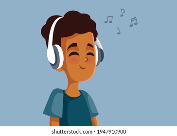 African Teen Boy Wearing Headphones Listening to Music. Happy Afro-American teenager wearing headphones and humming a song 
