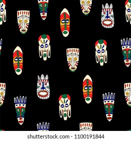 African tribal masks seamless pattern. Dark background. Hand drawn vector illustration.