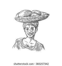African woman carries a basket with fruits on her head. Vector vintage engraved illustration isolated over white background.