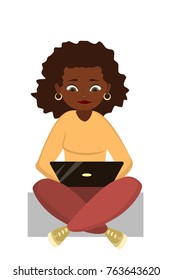 African woman with laptop sitting in lotus pose and working.