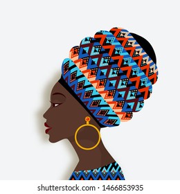 African woman in scarf and earrings in profile