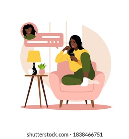 African woman sitting on sofa with phone. Working in phone. Freelance, online education or social media concept. Flat style. Vector illustration isolated on white.