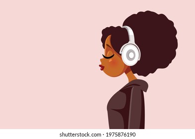 African Young Woman Listening to Music with Headphones. Young girl with lovely Afro hairstyle wearing headset enjoying soundtrack playlist
