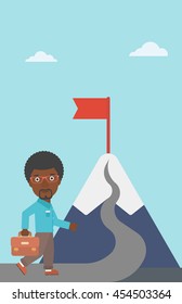 An african-american businessman walking on a road leading to the flag on the top of the mountain. Vector flat design illustration. Vertical layout.