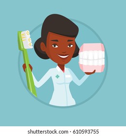 African-american dentist holding dental jaw model and a toothbrush in hands. Dentist showing dental jaw model and toothbrush. Vector flat design illustration in the circle isolated on background.