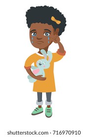 African-american girl crying and wiping the tears away. Little girl crying and holding toy rabbit in hand. Vector sketch cartoon illustration isolated on white background.