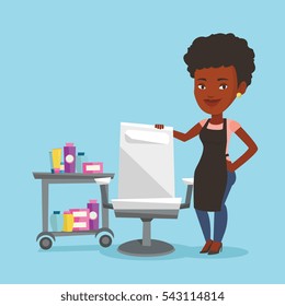 An african-american hairdresser standing near armchair and table with cosmetics in beauty saloon. Hairdresser standing at workplace in beauty saloon. Vector flat design illustration. Square layout.