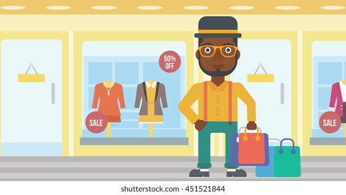 An african-american man holding shopping bags on the background of boutique window with dressed mannequins. Happy young man carrying shopping bags. Vector flat design illustration. Horizontal layout.