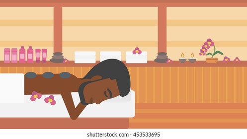 An african-american man relaxing while getting stone therapy massage in the spa center. Man having back massage in spa salon. Vector flat design illustration. Horizontal layout.