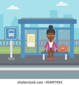 An african-american woman with briefcase waiting for a bus at a bus stop on a city background. Young woman sitting at bus stop at the city street. Vector flat design illustration. Square layout.