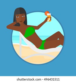 An african-american woman sitting in a chaise longue on the beach. Young woman relaxing and drinking a cocktail on a sand beach. Vector flat design illustration in the circle isolated on background.