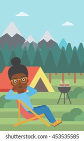 An african-american woman sitting in a folding chair in the camp. Travelling woman relaxing and enjoying her camping holiday near the tent. Vector flat design illustration. Vertical layout.