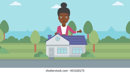 An african-american woman standing behind the house and showing thumb up. Female real estate agent offering the house. Young woman giving thumb up. Vector flat design illustration. Horizontal layout.