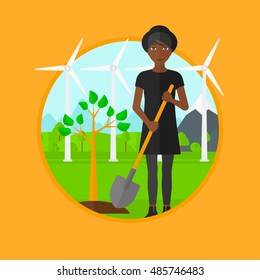 An african-american woman standing with shovel near newly planted tree. Woman planting tree on a background of wind turbines. Vector flat design illustration in the circle isolated on background.