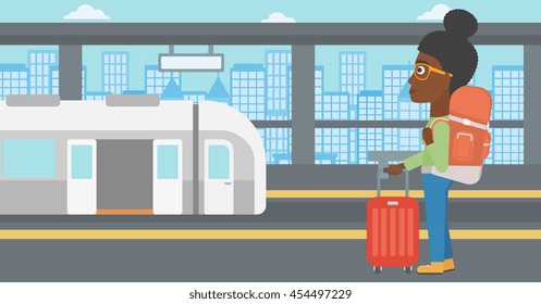 An african-american woman standing at the train station on the background of train with open doors. Young woman with suitcase waiting for a train. Vector flat design illustration. Horizontal layout.