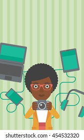 An african-american woman taking photo with digital camera. Woman surrounded with her electronic gadgets. Woman using many electronic gadgets. Vector flat design illustration. Vertical layout.