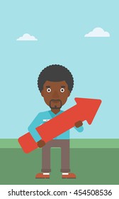 An african-american young businessman holding a big arrow in hands. Successful business concept. Vector flat design illustration. Vertical layout.
