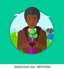 An african-american young man holding in hands green small plant in soil on a background with solar pannels and wind turbins. Vector flat design illustration in the circle isolated on background.