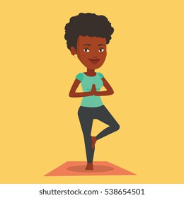 An african-american young sportswoman standing in yoga tree pose. Sportswoman meditating in yoga tree position. Sporty woman doing yoga on the mat. Vector flat design illustration. Square layout.