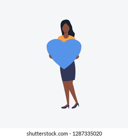 Afro woman holding blue heart. Romantic, girlfriend, greeting. Can be used for topics like Saint Valentines Day, festival, celebration