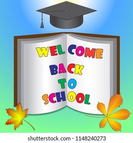 Against the background of autumn leaves, a book with an invitation to school, on top of a graduate cap.