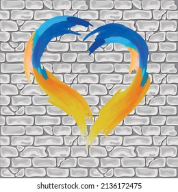 Against the background of a brick wall, a heart in the colors of the flag of Ukraine