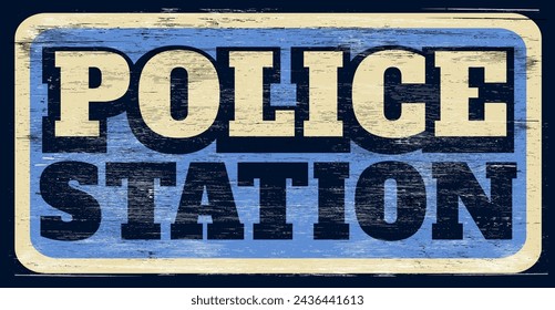Aged and worn police station sign on wood