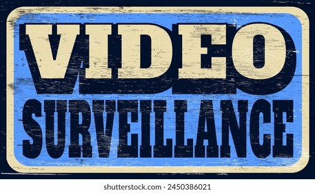 Aged and worn video surveillance sign on wood