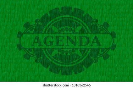 Agenda text inside grass sod realistic emblem. Eco graceful background. Artistic illustration. 