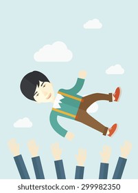 An aggressive japanese businessman being throwing up to the sky by his teamwork or colleague. Happiness concept. A contemporary style with pastel palette soft blue tinted background with desaturated